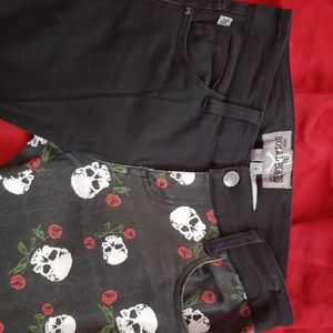 Royal Bones skinny pants with skulls and red roses